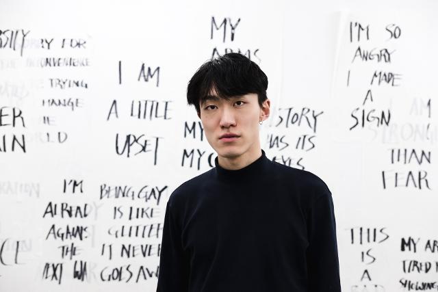 Isaac Chong Wai at ACUD Macht Neu in front of an installation of his work Rehearsal of the Futures: Is the World Your Friend?, Photo taken by Tobias König